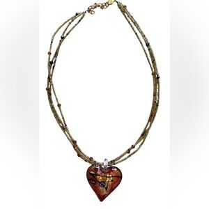 Beaded necklace with a red glass heart pendant